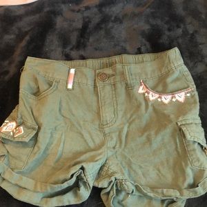 Army green shorts with pink and white pattern on front, from justice